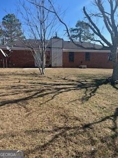 view of side of home featuring a yard