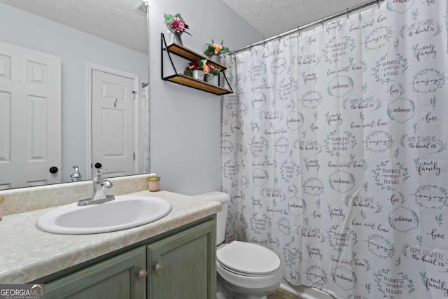 bathroom featuring a textured ceiling, toilet, a shower with shower curtain, and vanity