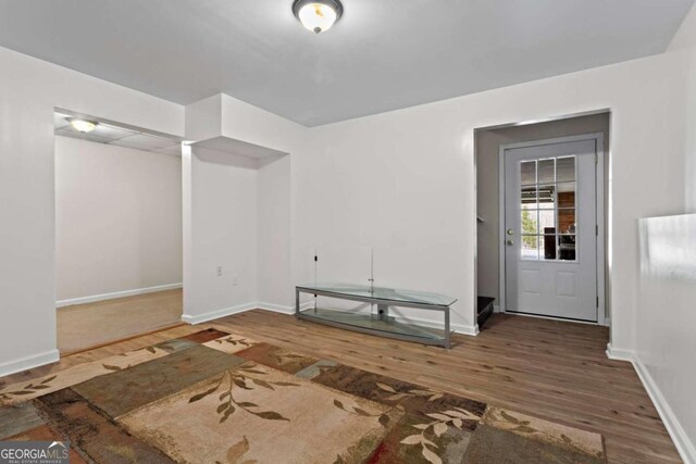 interior space with dark wood finished floors and baseboards