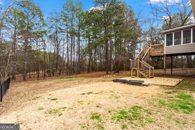 view of yard with a deck and stairs