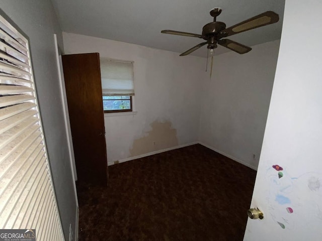 unfurnished room featuring carpet floors, baseboards, and a ceiling fan