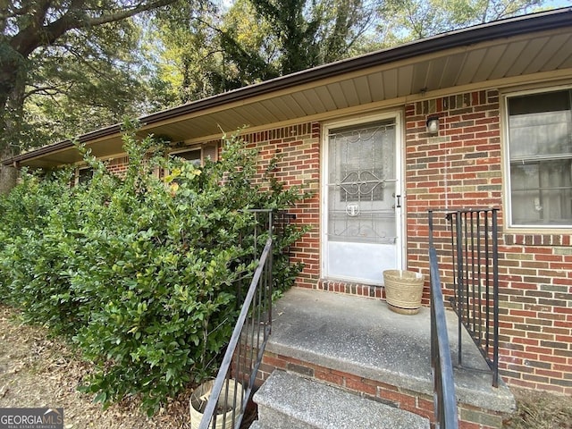 property entrance with brick siding