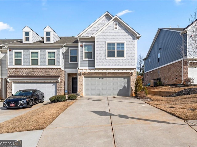 view of front facade with a garage, concrete driveway, and brick siding