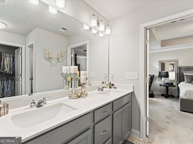 full bathroom featuring visible vents, a sink, ensuite bath, and double vanity