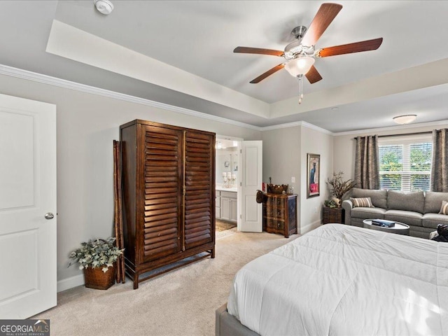 bedroom featuring a tray ceiling, light colored carpet, and baseboards