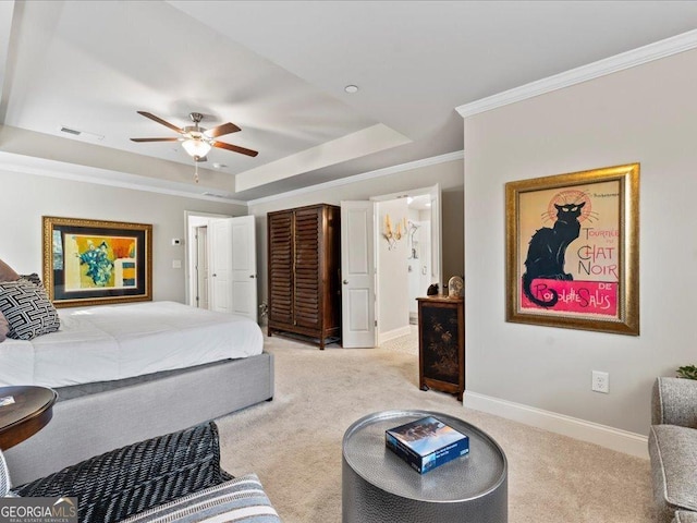 bedroom featuring light colored carpet, visible vents, baseboards, ornamental molding, and a raised ceiling