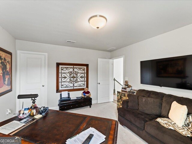 home office featuring light carpet and baseboards