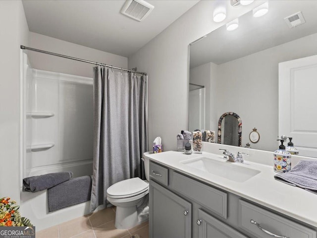 bathroom featuring a shower with shower curtain, visible vents, toilet, and tile patterned floors