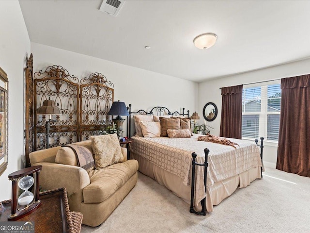 bedroom featuring visible vents and light carpet