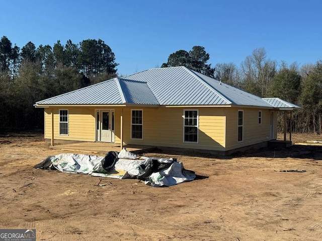 back of house with a standing seam roof and metal roof