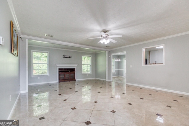 unfurnished living room with ornamental molding, a healthy amount of sunlight, visible vents, and a fireplace