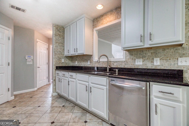 kitchen featuring a sink, visible vents, white cabinets, stainless steel dishwasher, and backsplash