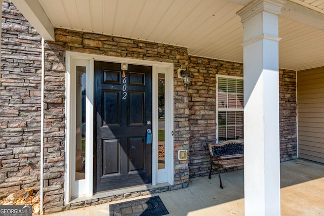 property entrance featuring stone siding