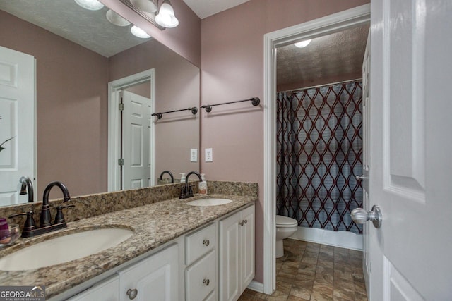 full bath with a shower with shower curtain, a sink, toilet, and double vanity