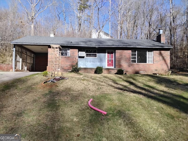 ranch-style home with an attached carport, brick siding, a chimney, and a front yard