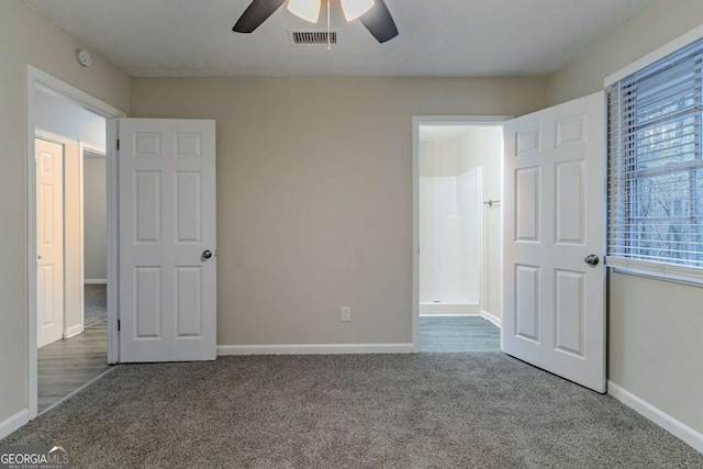 unfurnished bedroom with carpet, visible vents, baseboards, and ceiling fan