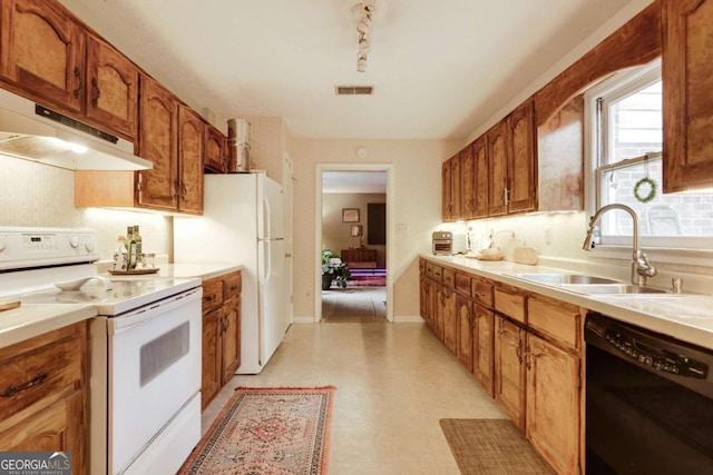 kitchen featuring white appliances, visible vents, brown cabinets, light countertops, and under cabinet range hood