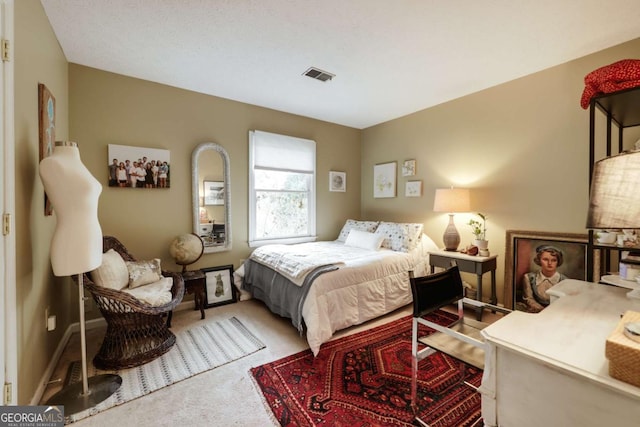 carpeted bedroom with visible vents and baseboards