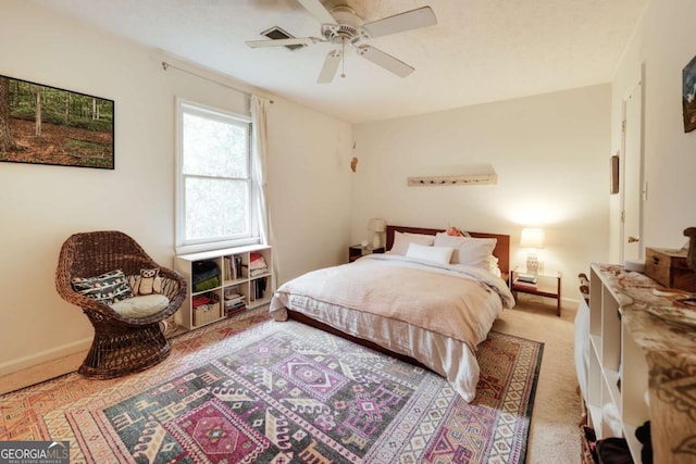 bedroom with light colored carpet, ceiling fan, a textured ceiling, and baseboards