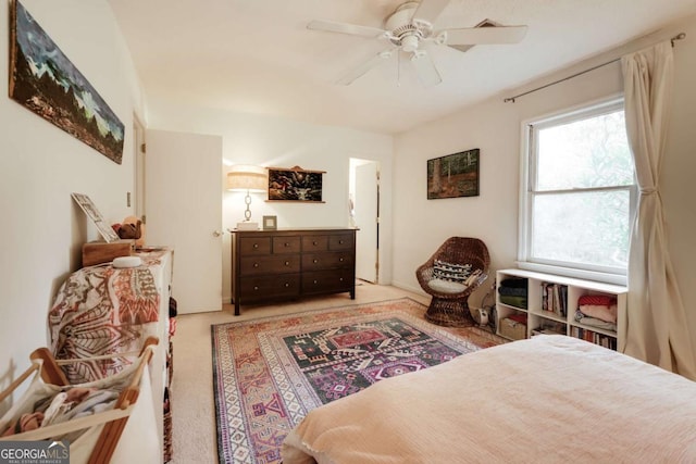 bedroom featuring a ceiling fan and light colored carpet