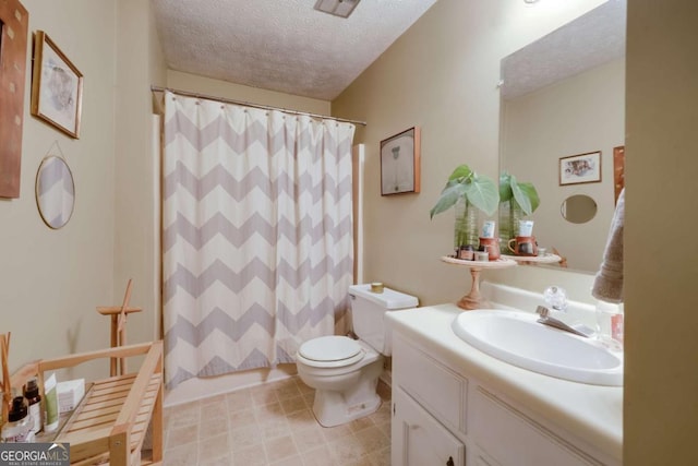 bathroom with curtained shower, vanity, toilet, and a textured ceiling