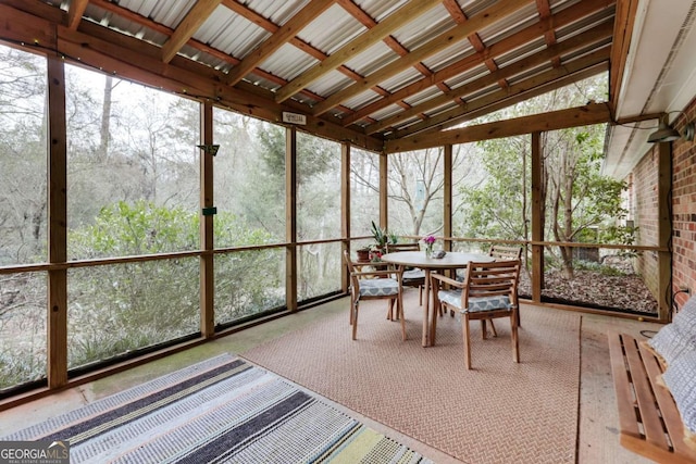 sunroom featuring vaulted ceiling