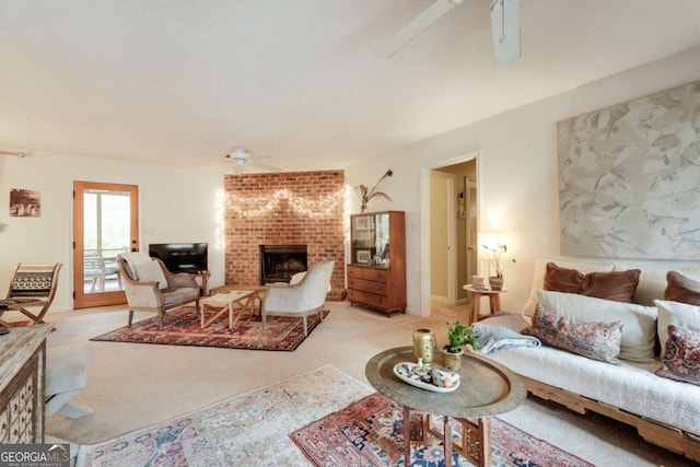 living area featuring light carpet, a brick fireplace, and a ceiling fan