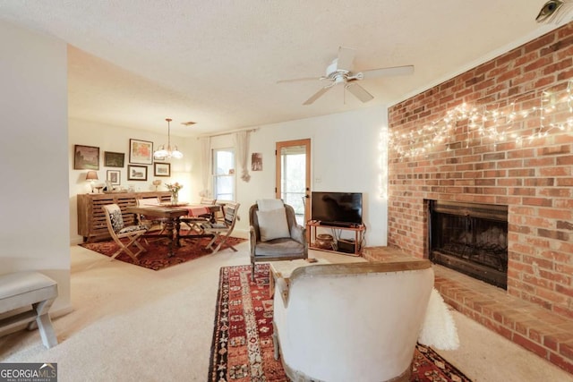 carpeted living area featuring a brick fireplace, a ceiling fan, and a textured ceiling