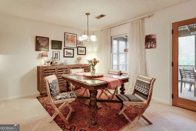 dining space with light carpet, a healthy amount of sunlight, and visible vents