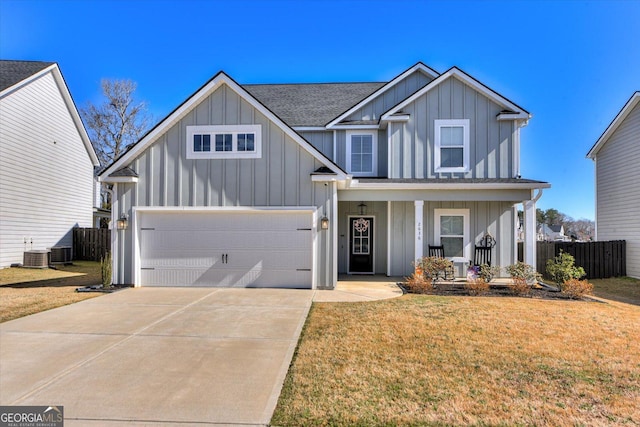 view of front facade with a porch, board and batten siding, a front yard, a garage, and driveway