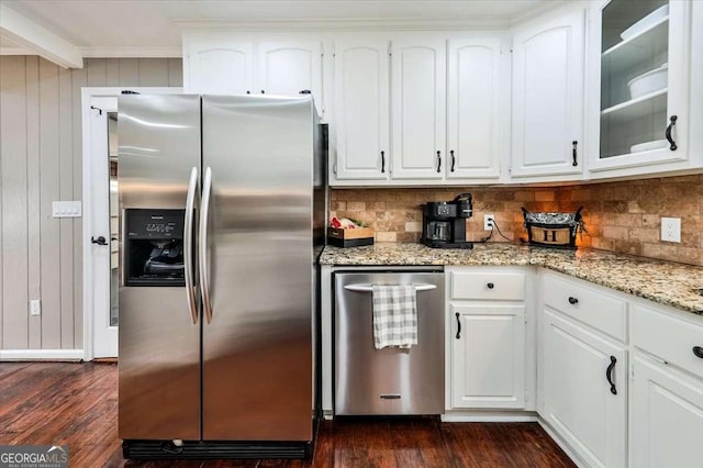 kitchen with glass insert cabinets, white cabinetry, light stone counters, and stainless steel fridge with ice dispenser