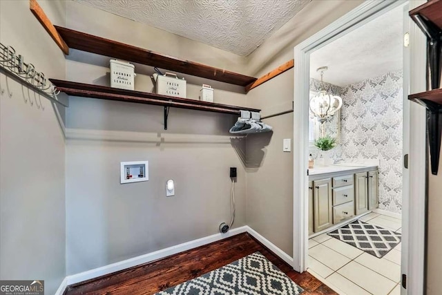 washroom featuring washer hookup, hookup for an electric dryer, wood finished floors, laundry area, and baseboards