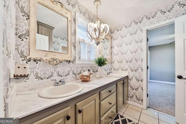 full bathroom featuring double vanity, wallpapered walls, and a sink