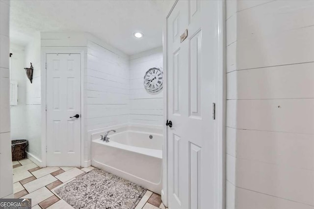 bathroom featuring a garden tub and recessed lighting