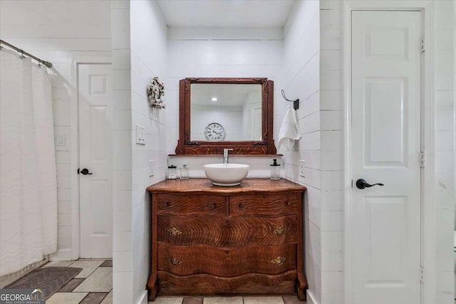 bathroom featuring a closet, vanity, and tile patterned floors