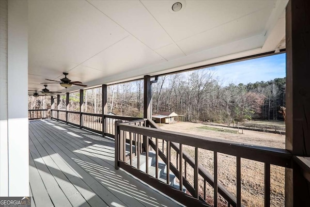 wooden deck featuring ceiling fan