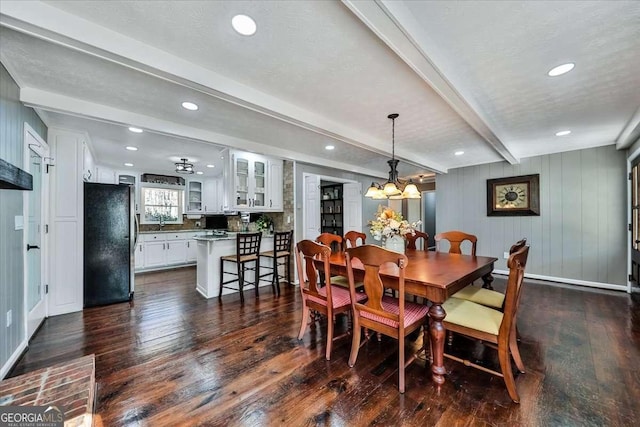 dining space with dark wood-style flooring, beamed ceiling, and recessed lighting