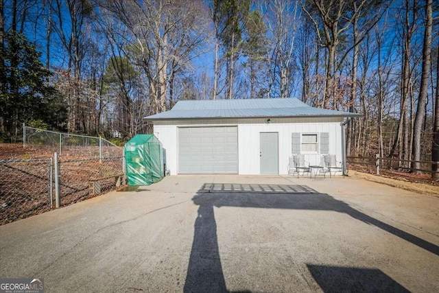 garage with fence and driveway