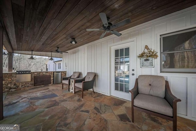 view of patio / terrace with a sink, a ceiling fan, and exterior kitchen