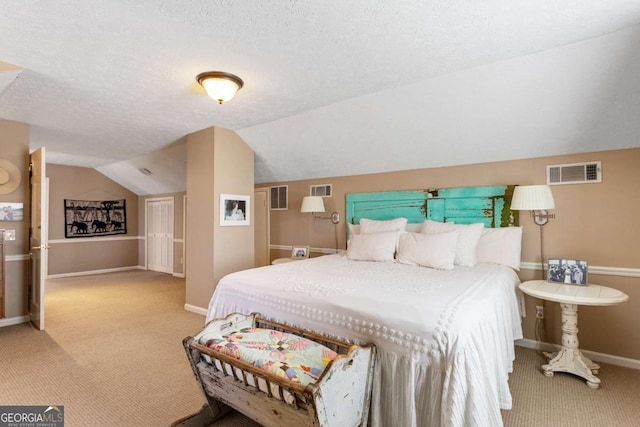 carpeted bedroom featuring lofted ceiling, baseboards, visible vents, and a textured ceiling