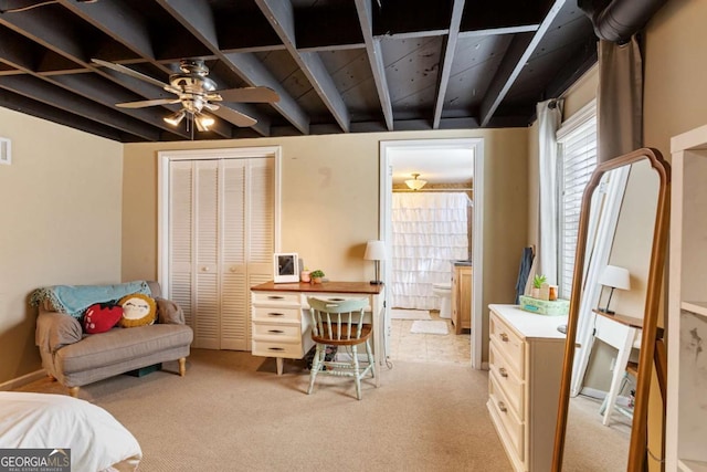 office area with light carpet, ceiling fan, visible vents, and beam ceiling