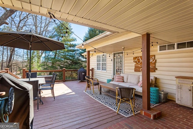 deck with outdoor dining area, an outdoor living space, and area for grilling