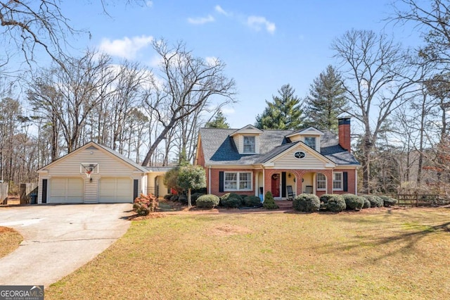 new england style home featuring concrete driveway, brick siding, a front lawn, and an attached garage