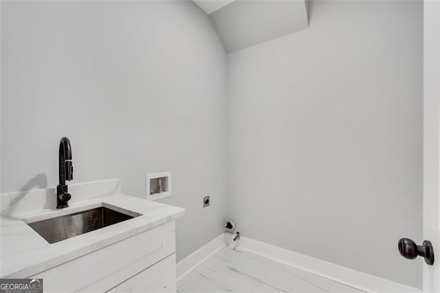 washroom with cabinet space, gas dryer hookup, a sink, hookup for a washing machine, and electric dryer hookup