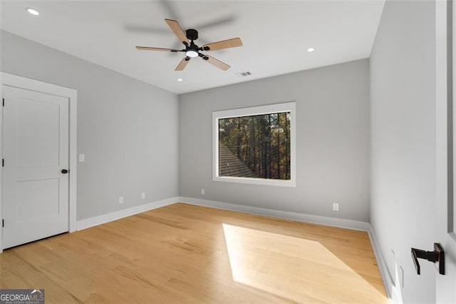 empty room featuring recessed lighting, wood finished floors, visible vents, and baseboards