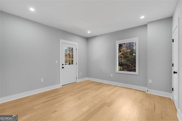 empty room featuring baseboards, recessed lighting, and light wood-style floors