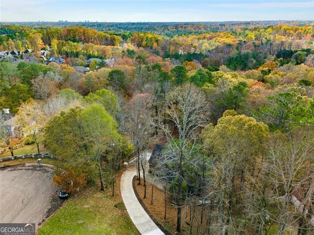 bird's eye view featuring a wooded view