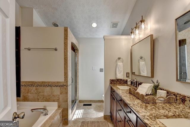 full bath featuring a garden tub, double vanity, visible vents, a sink, and a textured ceiling