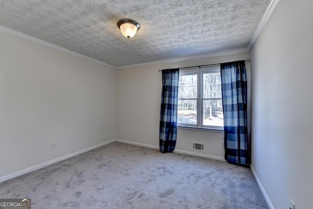 carpeted spare room with baseboards, visible vents, a textured ceiling, and ornamental molding