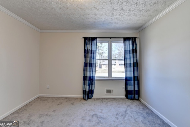 carpeted empty room with crown molding, a textured ceiling, visible vents, and baseboards